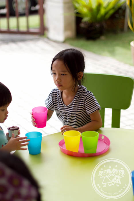 Zaria serving water to her friends